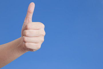 Thumb up isolated on blue background. 
