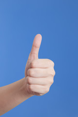 Thumb up isolated on blue background. 