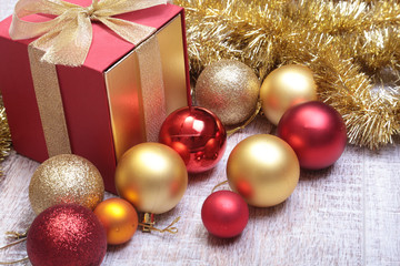 Gift boxes with many christmas balls on wood background