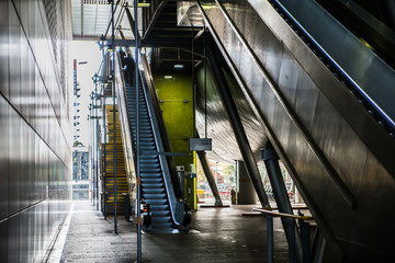 Naklejka premium Modern architecture, Train station with escalators, supportive metal beams, tickets machine. Multiple exposure image 