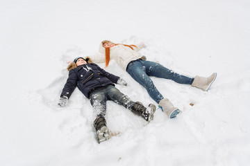 Fototapeta na wymiar mother and son having fun in the snow wonderful winter day