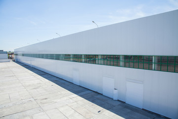facade of an industrial building and warehouse in length