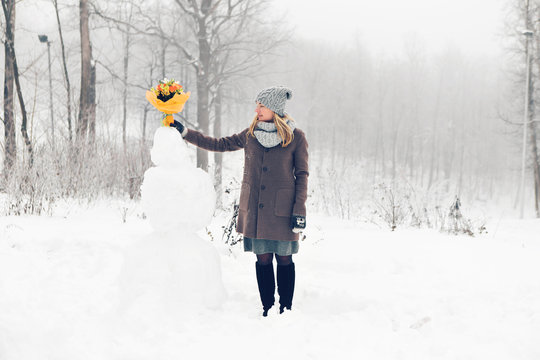 Woman make snowman
