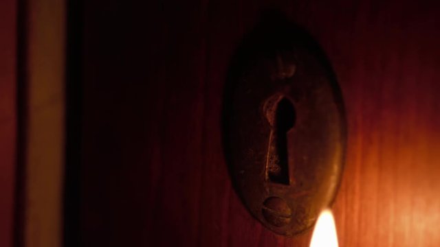 Skeleton Key Inserted In Door By Candlelight