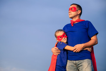 Father and daughter playing superhero at the day time.