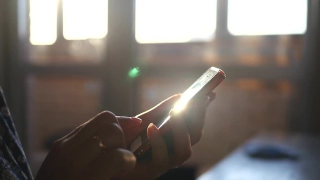 phone glares at sunset