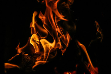 Fire burning inside a brick stove - wood, ash, flames