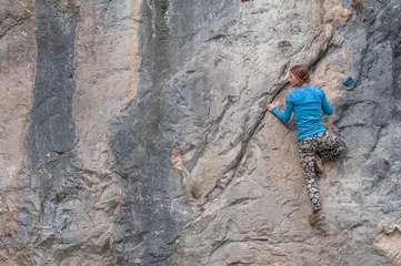 Rolgordijnen Young girl climbing up the rock in Turkey © dmytrobandak