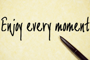 enjoy every moment text write on paper