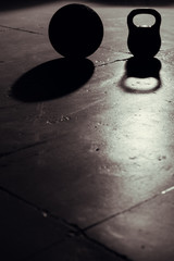 Kettlebell and ball backlight and shadow in gym