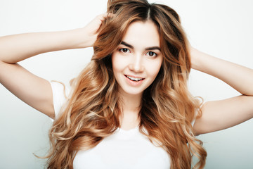 Fototapeta premium lifestyle and people concept: Young casual woman portrait. Clean face, curly hair. 