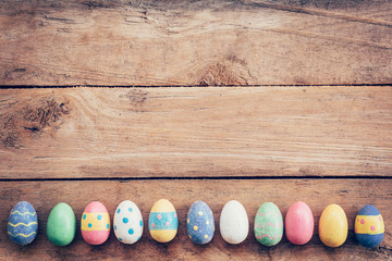 Colorful pastel easter eggs on wooden background with space. Vin