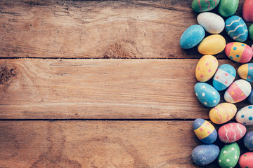 Colorful pastel easter eggs on wooden background with space. Vin