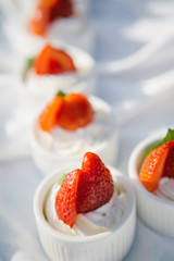 Cupcakes with whipped cream decorated with strawberry