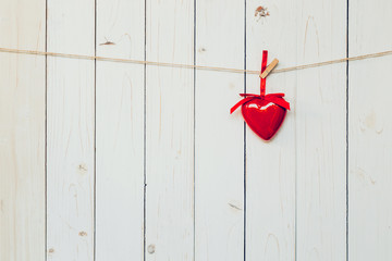 Decorative red hearts hanging on vintage wooden background with