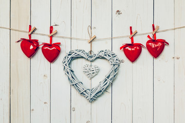 wooden rustic decorative hearts hanging on vintage wooden backgr