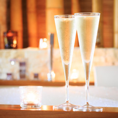 Two glasses of champagne with candle near jacuzzi. Valentines ba