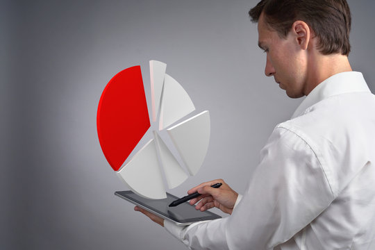 Man in white shirt working with pie chart on a tablet computer, application for budget planning or financial statistics.