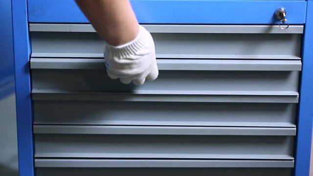 mechanic takes out tool from the box