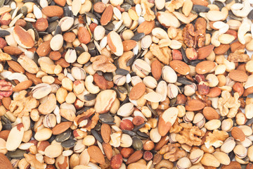 Background of mixed nuts: pistachios, peanuts, walnuts, almonds, hazelnuts, Brazil nuts, pumpkin seed and cashews mixed together