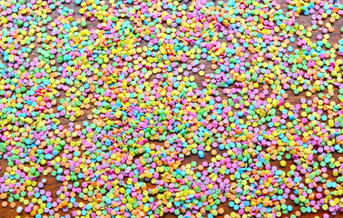 Fototapeta na wymiar Sugar sprinkle dots, decoration for cake and bakery, a lot of sprinkles as a background