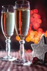 Two wineglasses of champagne and new year's decorative wood star