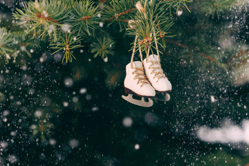 Closeup christmas tree decoration small ice skates on the rope