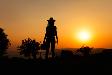 Silhouette capture of a woman wearing cowboy hat