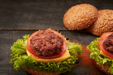 Two hamburger on a wooden table