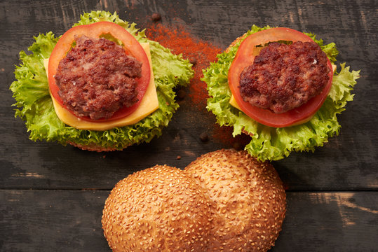 Two hamburger on a wooden table