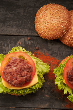 Two hamburger on a wooden table