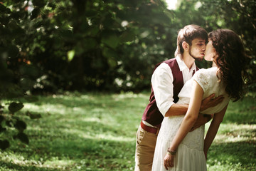 Wedding couple dancing in park