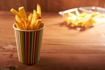 fried French fries close up in paper cup
