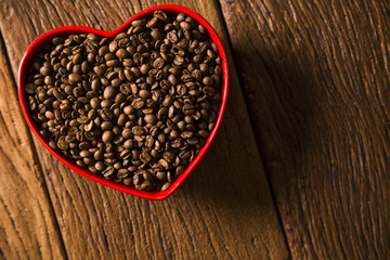Coffee love concept. Coffee beans in heart into the bown
