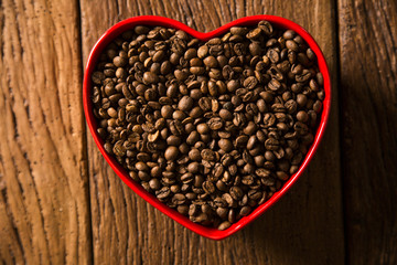 Coffee love concept. Coffee beans in heart into the bown