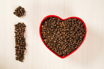 Coffee love concept. Coffee beans in heart into the bown