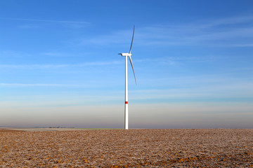 Windmill generator in wide yard / Yard of windmill power generatorunder blue sky, shown as energy industry concept