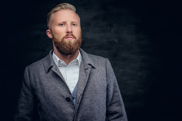 Serious  bearded man dressed ina white shirt and classic, elegan