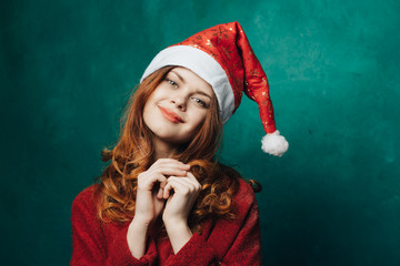 happy woman on New Year in a New Year's cap in bright background
