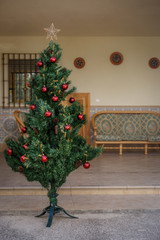 Fototapeta na wymiar An artificial christmas tree with some balls