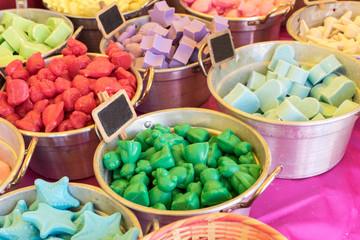 colored soaps in different forms at a market
