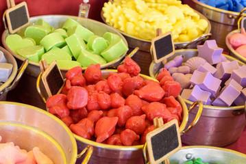 colored soaps in different forms at a market