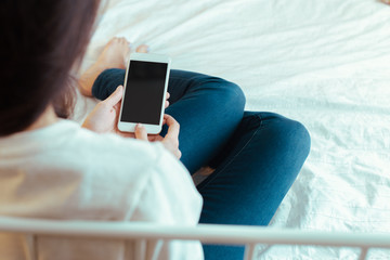Woman with modern mobile phone in hands