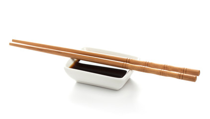 Soy sauce and chopsticks isolated on white background, with clipping path