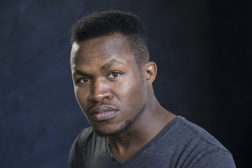 Obraz premium Portrait of a young black man with a serious expression