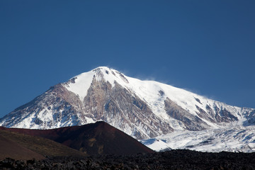 Peak Tolbachik in Kamchatka. Snow-capped peak against the blue sky