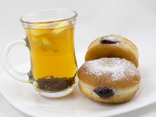 Transparent Cup with Tea and a Donut