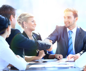 Two business colleagues shaking hands during meeting