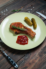 grilled beef steak and cucumber, garlic sauce on dark plate