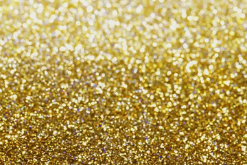 Glitter and glow soft gold bokeh shining light abstract dreamy sparkle background